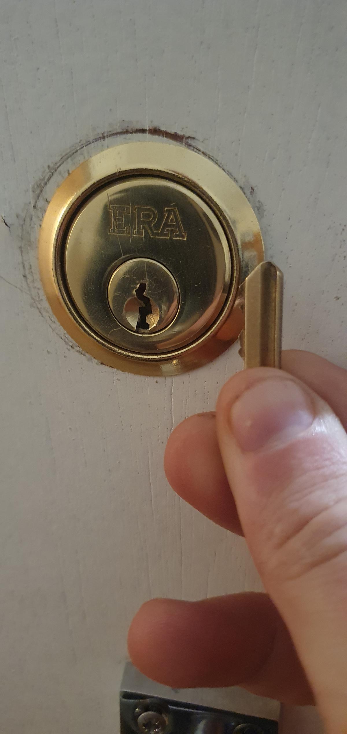 A broken lock with a key snapped inside