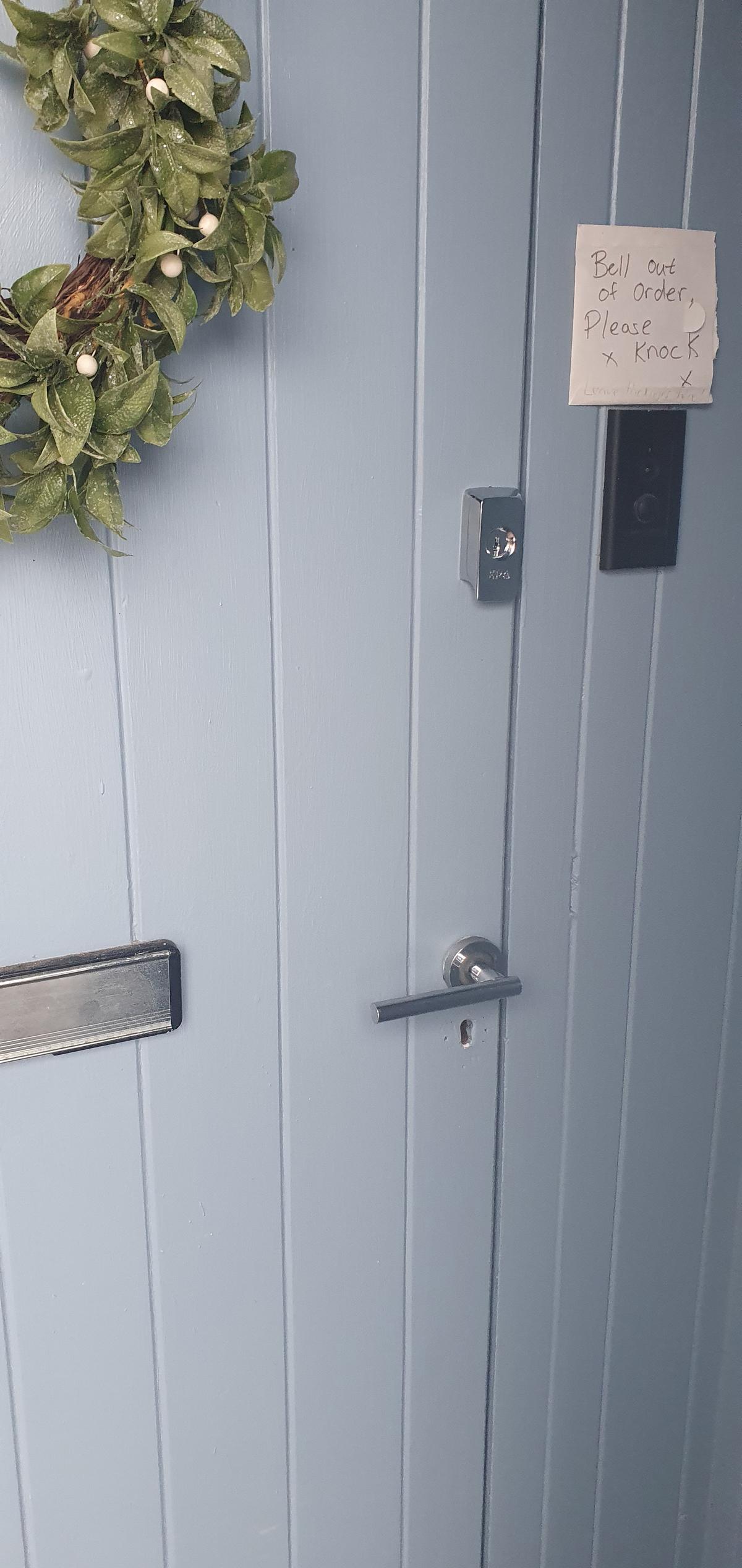 Anthony from AD Locksmithing holding open a door with a pick that has been opened when the customer was locked out and rang for an emergency locksmith