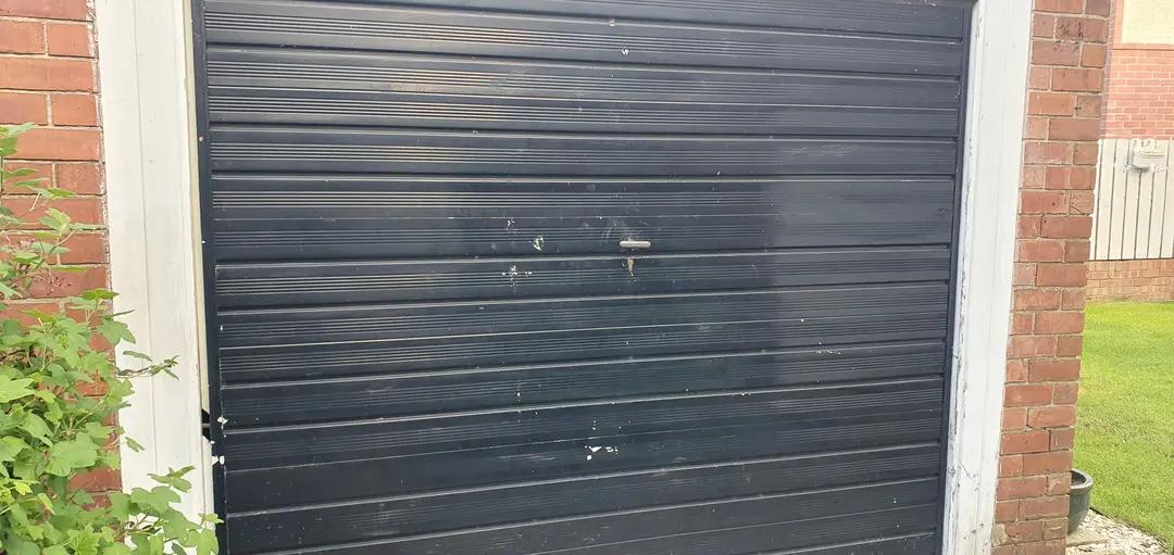 Professional locksmith performing an emergency garage door repair
