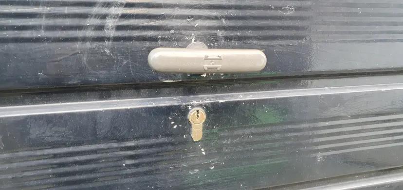 Close-up of a garage door lock being expertly repaired