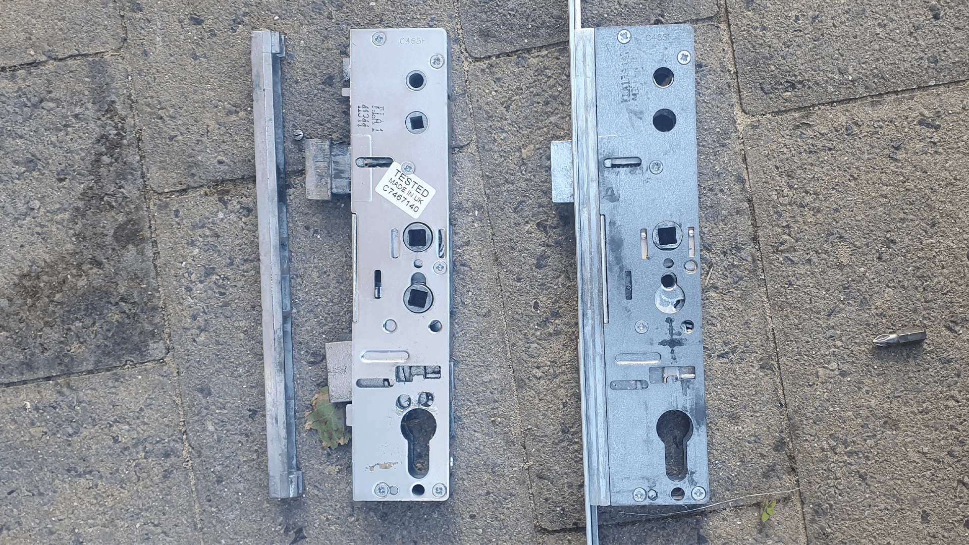Locksmith installing replacement door lock mechanism after successful entry