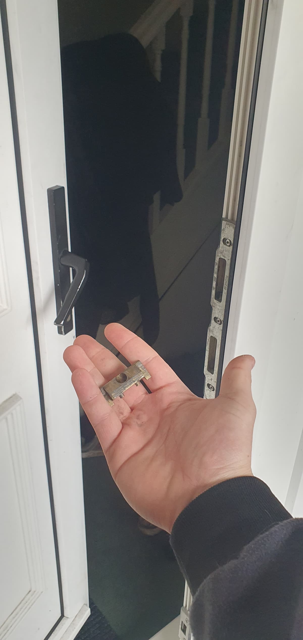 AD Locksmithing holding part of a broken door lock