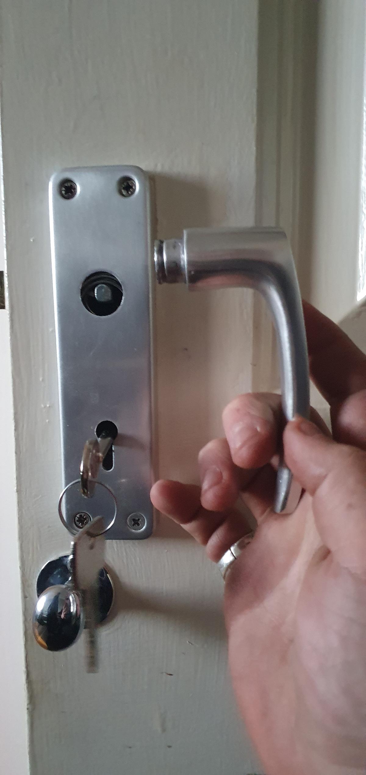 A photo of a door handle on door repair job by AD Locksmithing