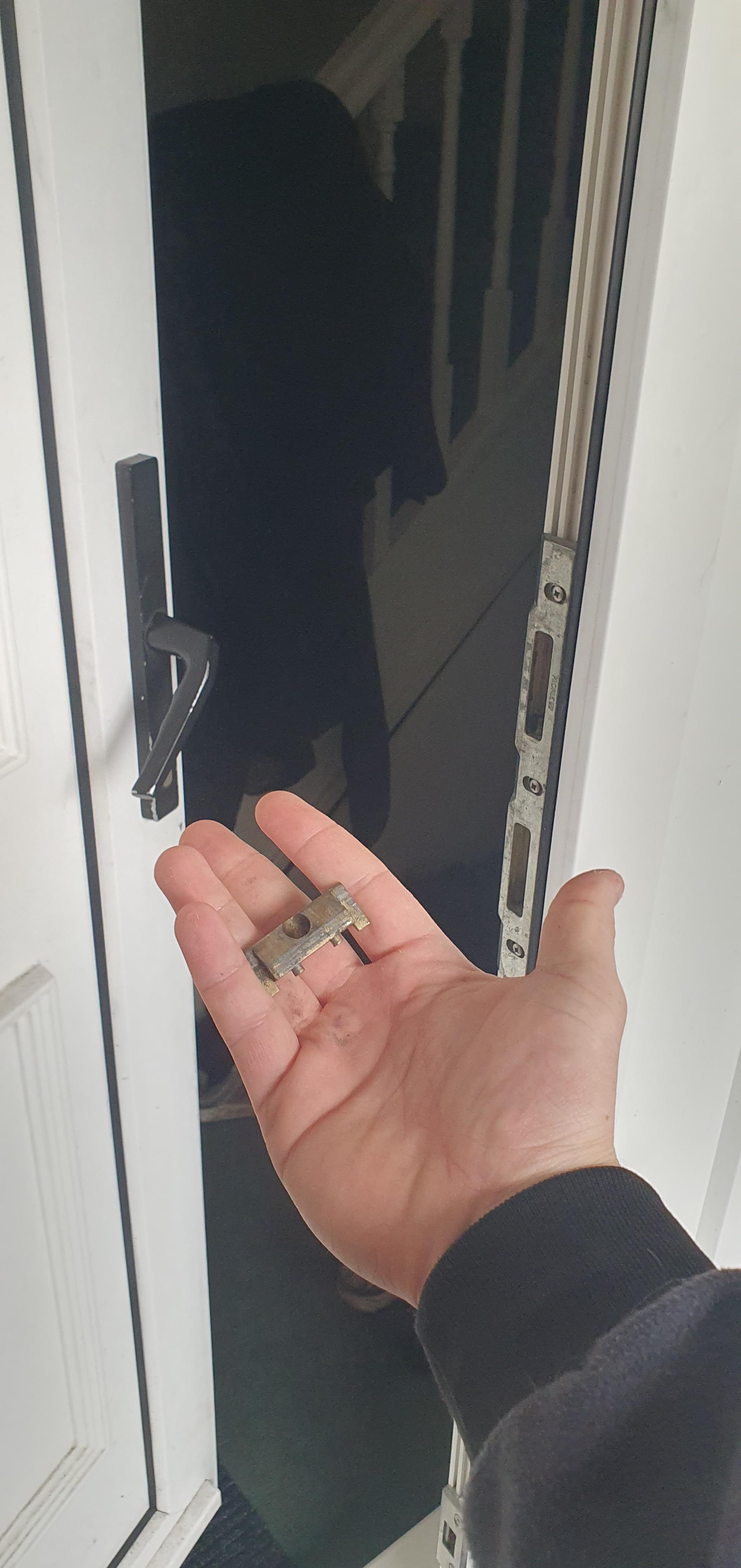 Anthony from AD Locksmithing holding open a door with a pick that has been opened when the customer was locked out and rang for an emergency locksmith